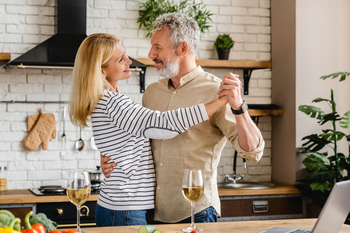 couple hugging kitchen Happy couple dancing in kitchen