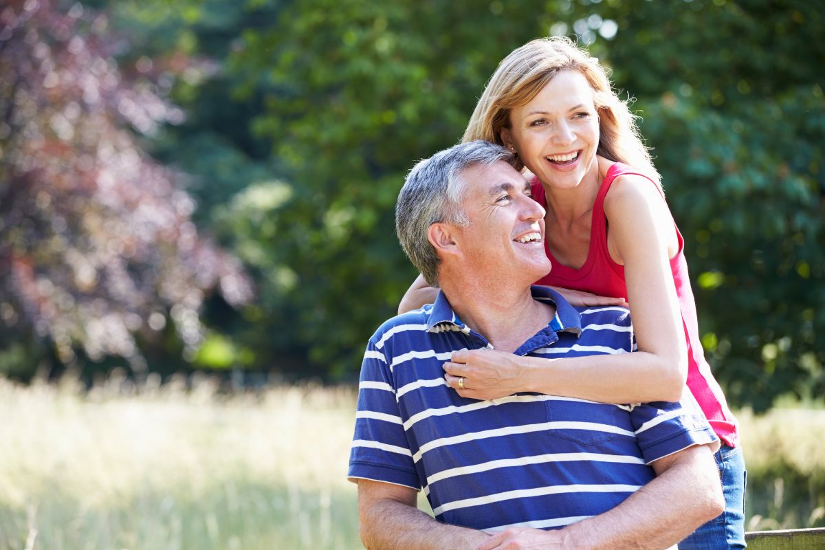 Middle aged couple embracing outdoors